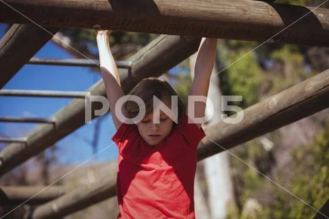 Girl climbing monkey bars during obstacle course training Stock Image ...