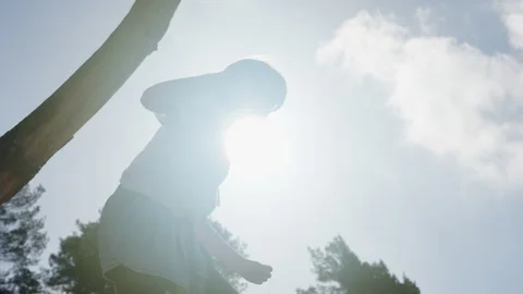 Girl climbing tree. Backlight Video stock 240543868