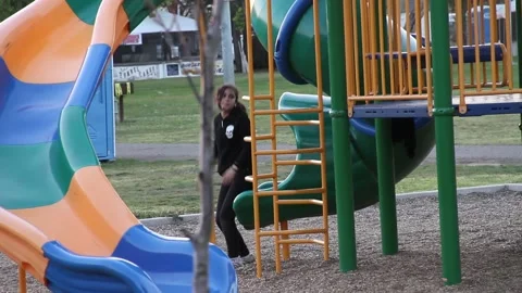 Girl climbs up slide the wrong way Stock Footage 154992758