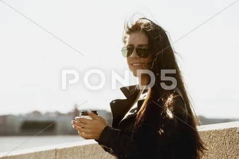 Girl with coffee on city background Stock Photos