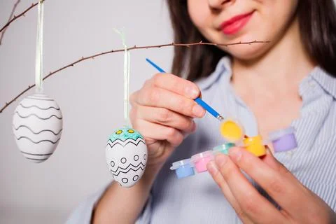 Girl coloring decorative Easter eggs for decoration at home before holiday .. Foto stock