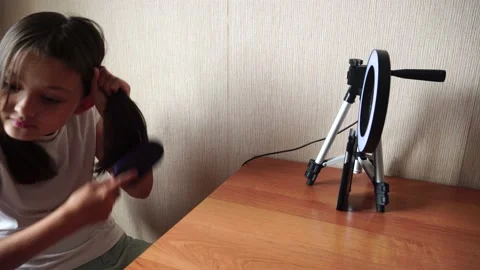 Girl combing in front of the camera Stock Footage 138681158