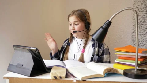 Girl communicates with the teacher using the Internet. Online education during Stock Footage 128707656