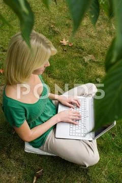 Girl On Computer In Garden