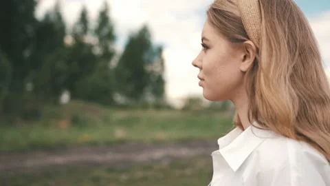 Girl with a control panel over a drone stands in a field Stock Footage 131204589