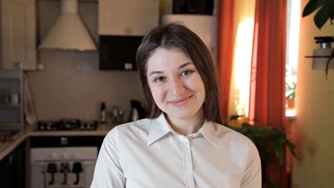 Girl cook posing in front of the camera with a cake dough and rolling pin Stock Footage 104837901