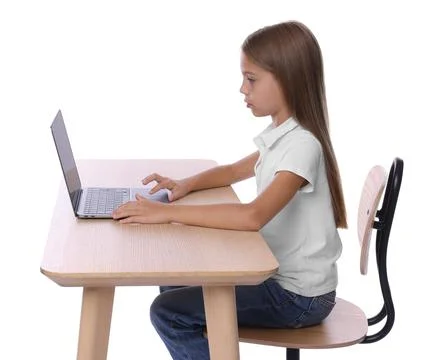 Girl with correct posture using laptop at wooden desk on white background Stock Photos