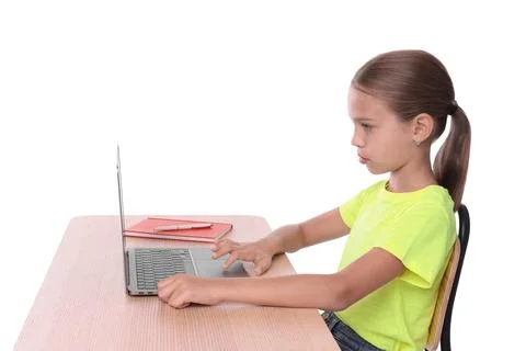 Girl with correct posture using laptop at wooden desk on white background Stock Photos