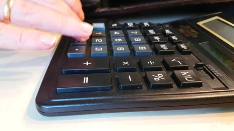 Girl counts hands on a calculator Video stock 80880103