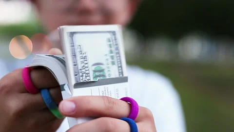 Girl counts stack of hundred-dollar bills Stock Footage 156762832