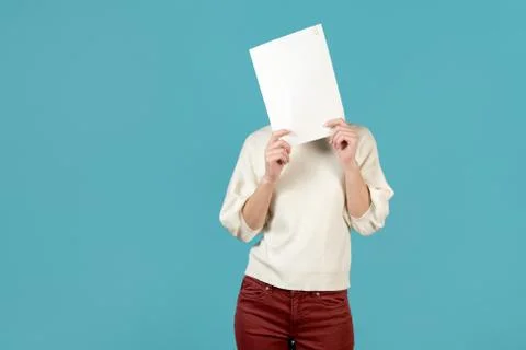 Girl covers her face with a stack of papers Stock Photos