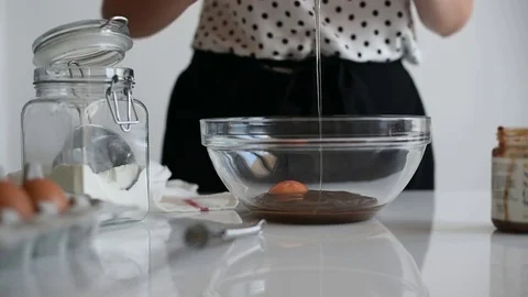 Girl cracking an egg in a bowl Stock Footage 79028039