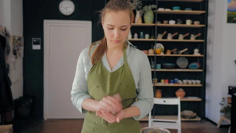 The girl crushes the clay in the hands Stock Footage 119541153