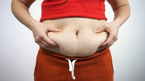 Girl is crying into the camera and looking at his folds of fat on the stomach Stock Footage 121887474