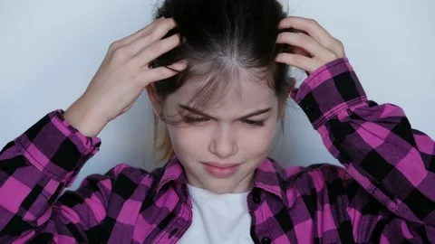 The girl is crying, grabbed her head,  infection with lice, allergy Stock Footage 141526807