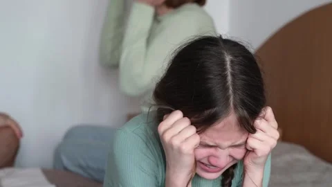 Girl crying while parents are arguing. Mother and father are getting a divorce Stock Footage 301894195