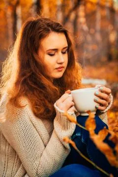 Girl with cup tea on a background of autumn forest Stock Photos