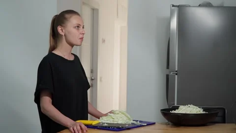 Girl cuts and eats cabbage Video stock 244480638