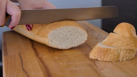 Girl cuts bread on the kitchen Stock Footage 88046480