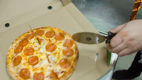 The girl cuts the cooked pizza Stock Footage 142400513