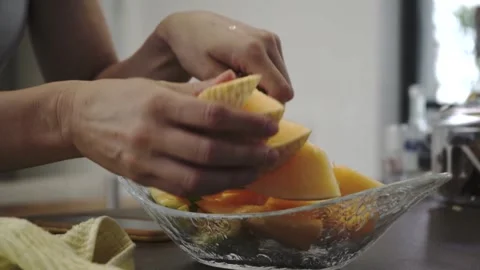 Girl cuts melon in the kitchen Stock Footage 133138918