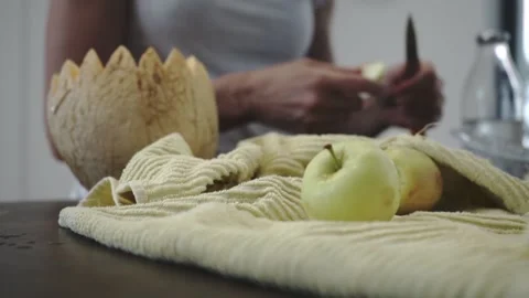 Girl cuts melon in the kitchen Stock Footage 133138923