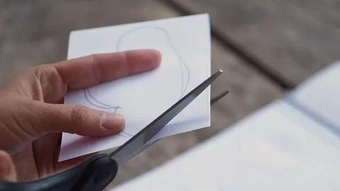 The girl cuts out a cloud from paper. Stock Footage 102775968