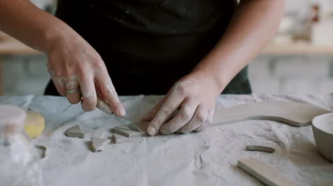 Girl cuts triangles of clay Stock Footage 68080179