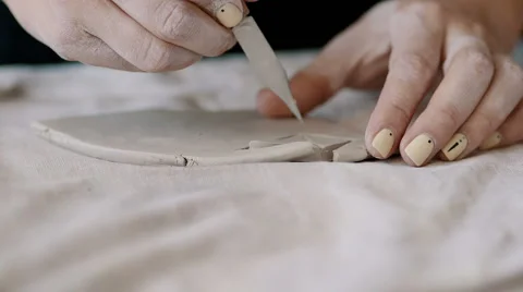 Girl cuts triangles of clay Stock Footage 68080555
