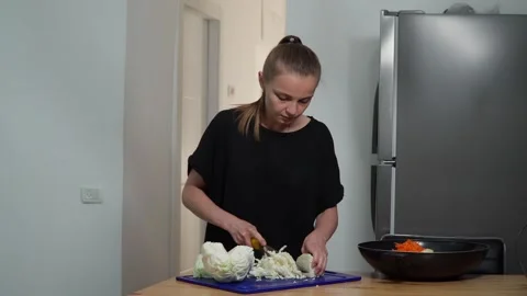 Girl cutting cabbage Stock Footage 244481048