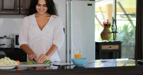 Girl Cutting Vegetables Using Tablet Computer Chatting Online, Young Woman Happy Stock Footage 75211128