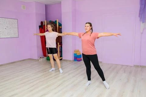 Girl dance instructor shows the elements of the number to another girl. Dance Stock Photos
