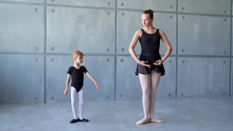 Girl dancer in ballet school learns to dance. Sweet girl learning to dance in Stock Footage