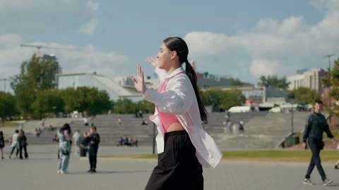 Girl dancer dancing energetic dance on the street in urban atmosphere Stock Footage 244395754