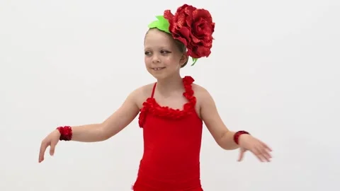 The girl dances salsa in a red suit. Dance movement. Children's hobby is to danc Stock Footage 242589385