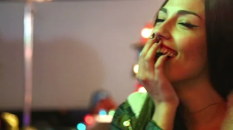 Girl dancing in amusement park, sending kiss and wink to the camera Stock Footage 59556182