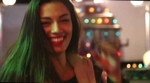 Girl dancing in amusement park, sending kiss and heart to the camera Stock Footage 59556191