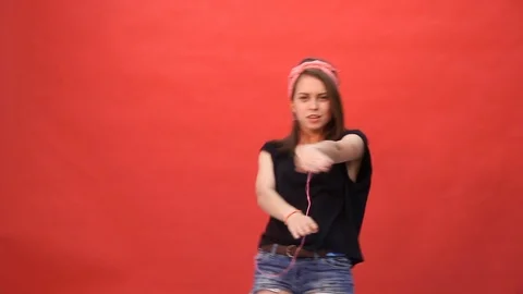 Girl dancing and having fun on a red background Vídeo Stock 103187361