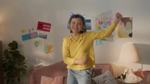 Girl Dancing and Jumping on Bed Listening to Music Stock Footage 317845588