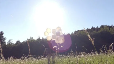 Girl dancing with balloons Stock Footage 76874930