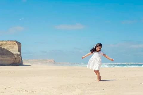 Girl dancing on the beach Stock Photos