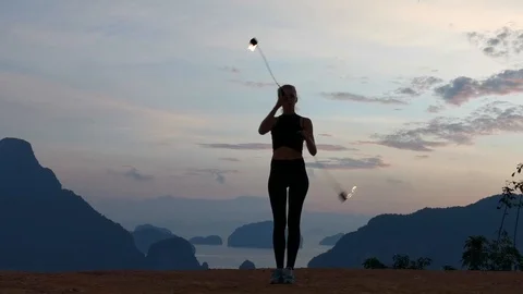 Girl dancing with fire shows fire show in a beautiful place Video stock 123125601