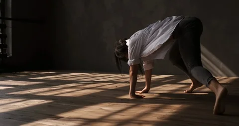 Girl dancing on the floor in the studio with large windows Stock Footage 116498312
