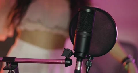 Girl dancing in front of a professional microphone. Female music performer .. Stock Footage 228830434