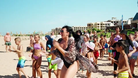 A girl is dancing merrily before the start of a foam disco on the beach. Stock Footage 346200583