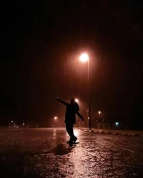 Girl dancing in the rain bokeh Stock Photos