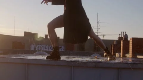 Girl Dancing On The Rooftops during Sunset Stock Footage 152156179