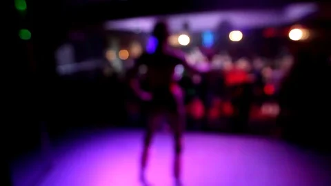 Girl dancing on stage on blurred background in the night club Stock Footage 72430222