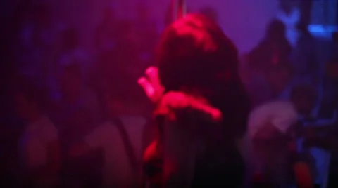 Girl dancing striptease on pylon in the night club Stock Footage