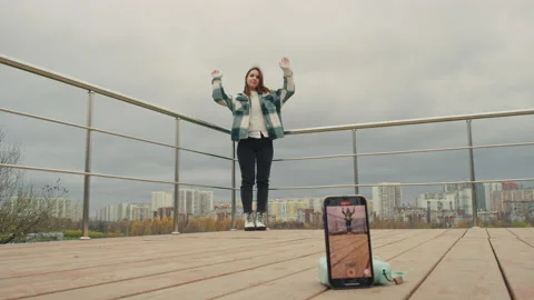The girl is dancing for TikTok. Red Helium 8K Stock-Footage 143238341